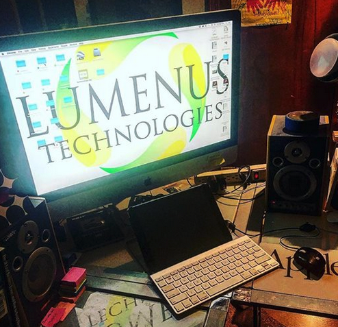A computer monitor displays the logo for luminus technologies