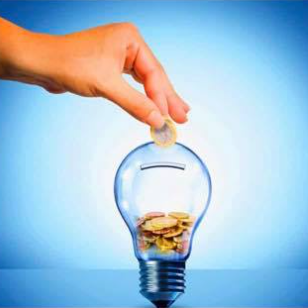 A hand is putting a coin into a light bulb filled with coins.