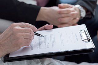 reviewing document on clipboard