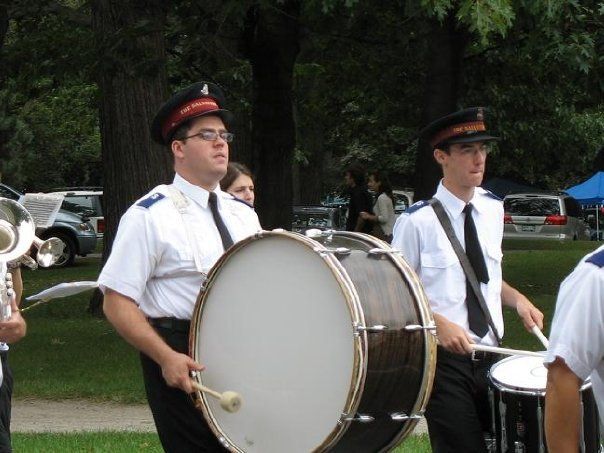 A man playing a drum in a marching band
