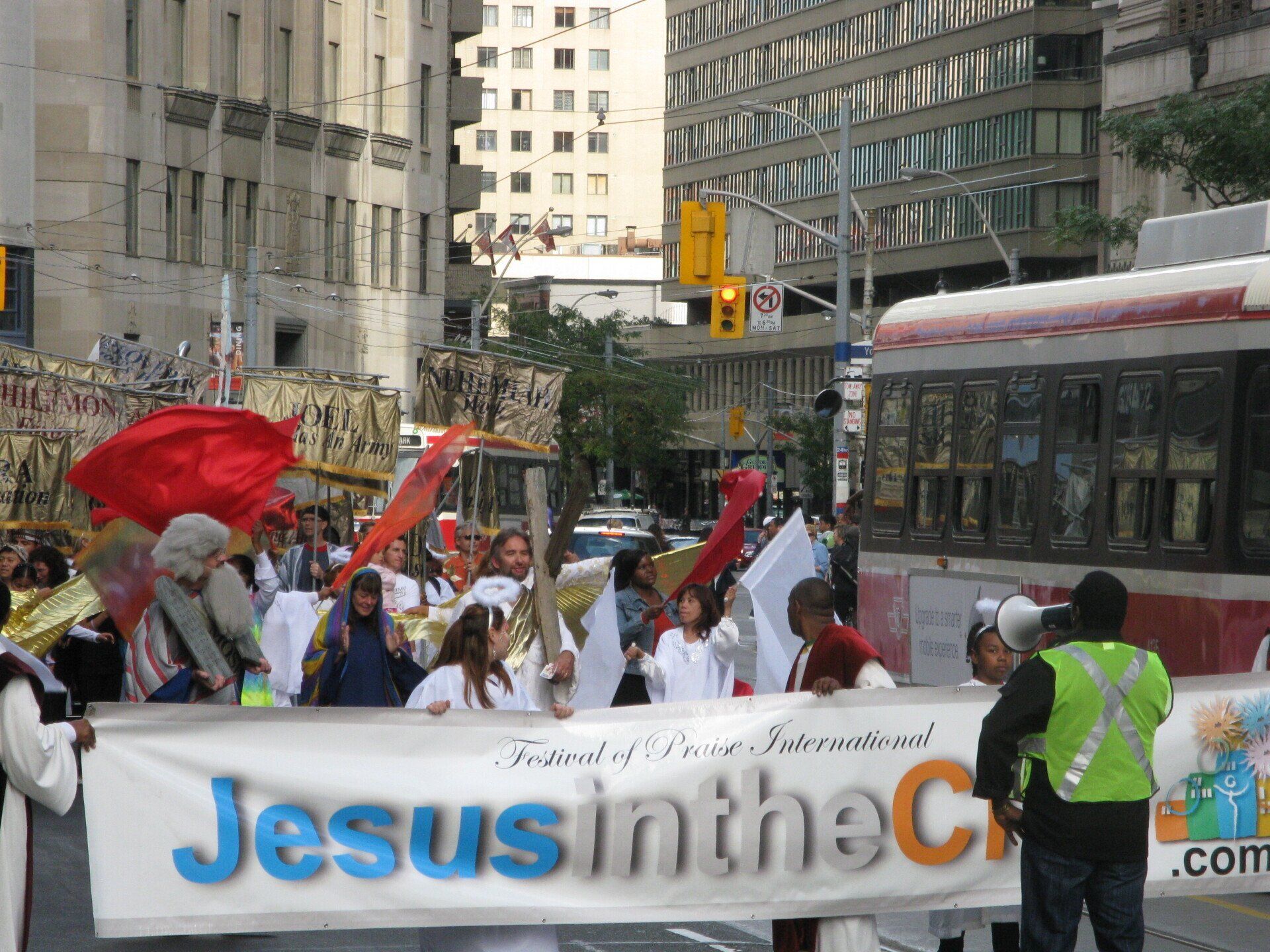 People holding a banner that says jesus in the city