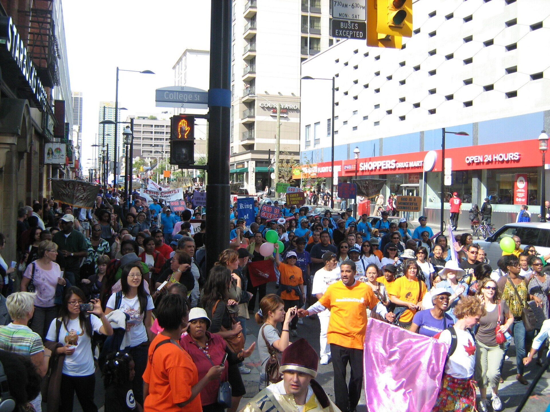 A large crowd of people are gathered on a city street