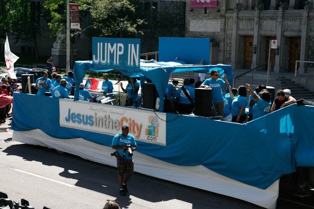 A jesus in the city parade float with people on it