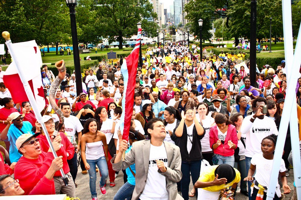 A large crowd of people are gathered in a park.