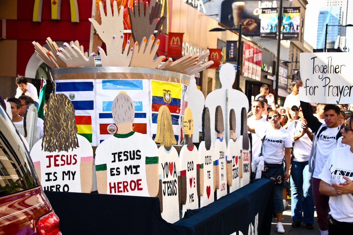 A group of people holding signs that say jesus is my hero