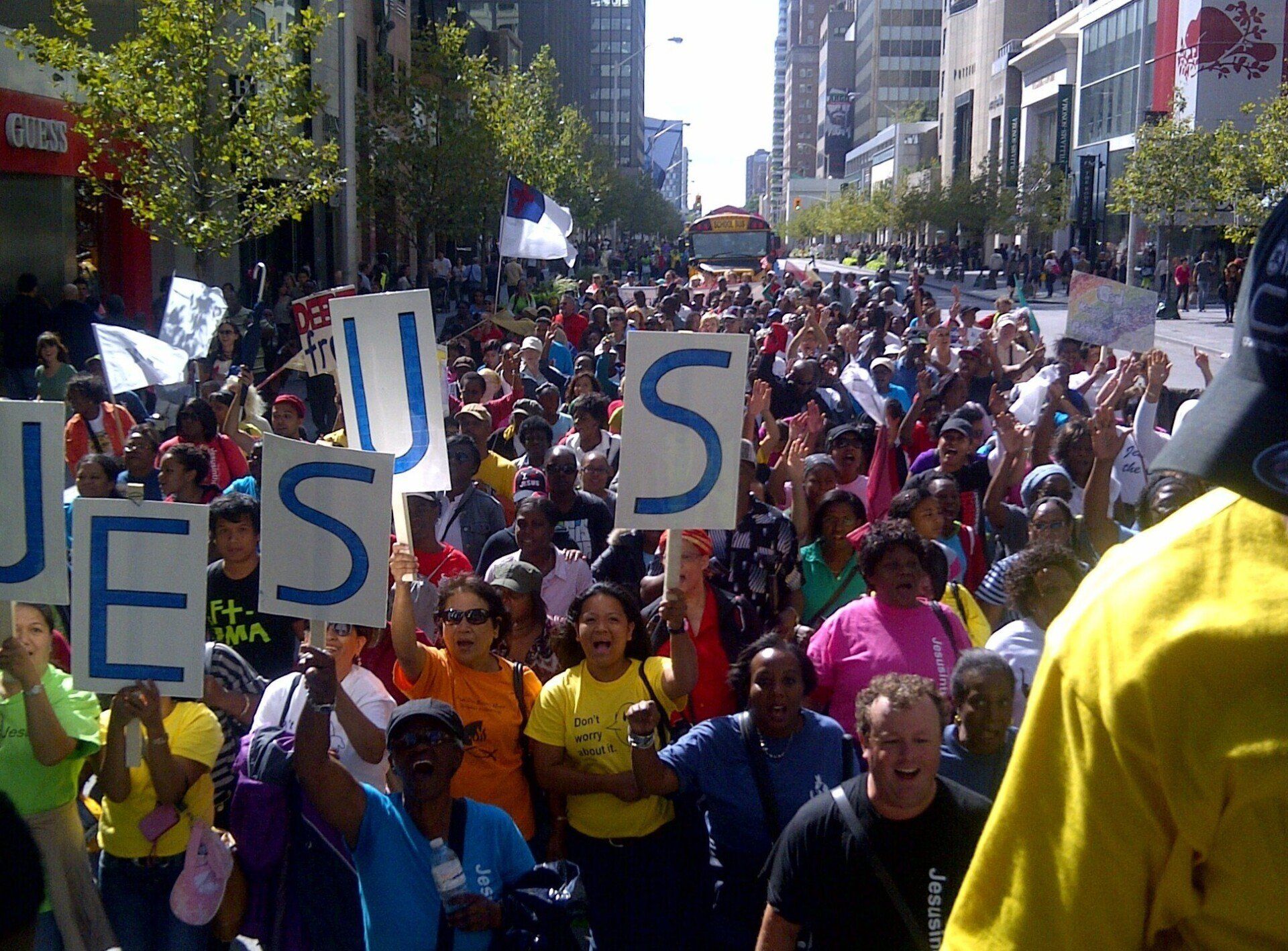 A crowd of people holding up signs that say jesus