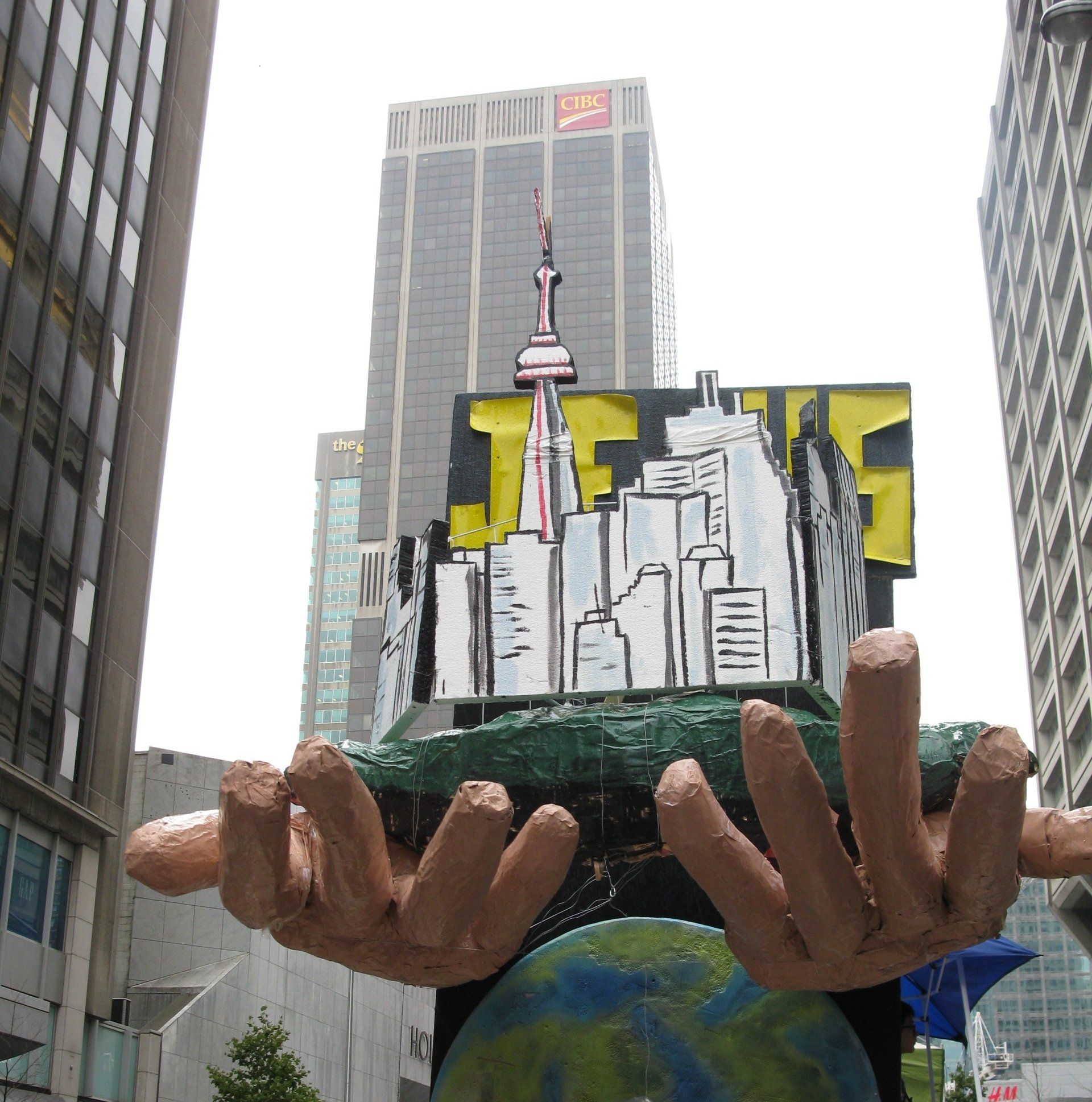 A statue of hands holding a globe and a sign that says jfk