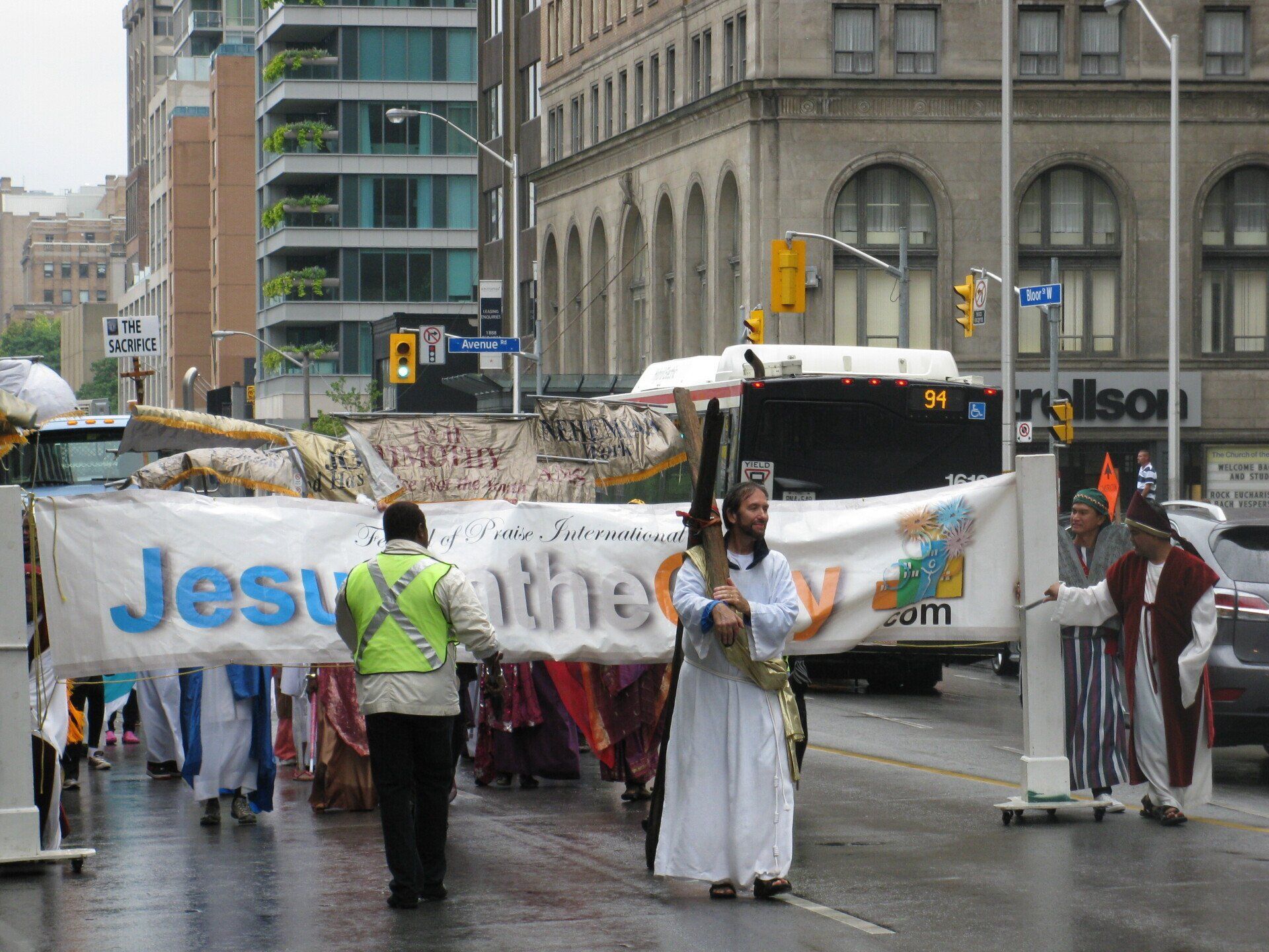 A man holding a banner that says jesus on it