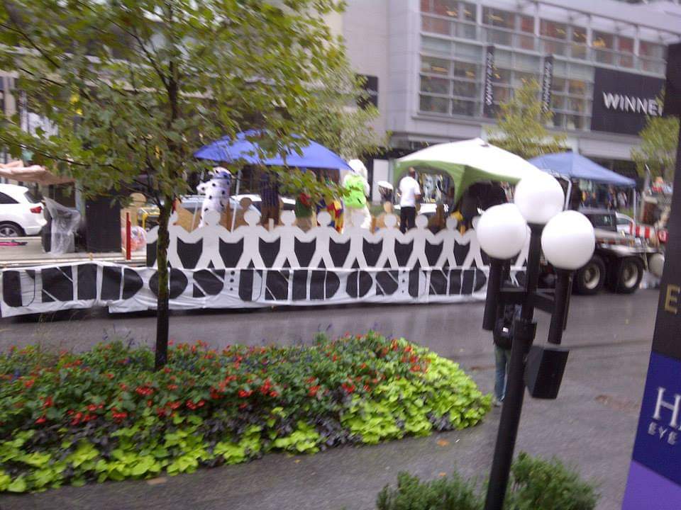 A group of people standing behind a sign that says united united united