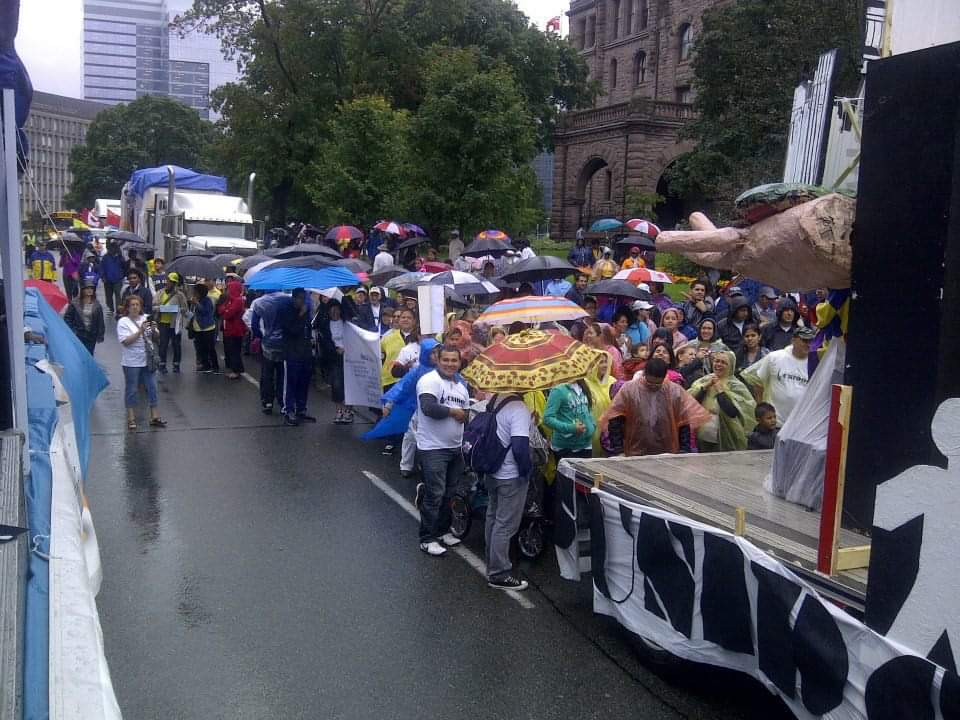 A large group of people are gathered on the side of the road