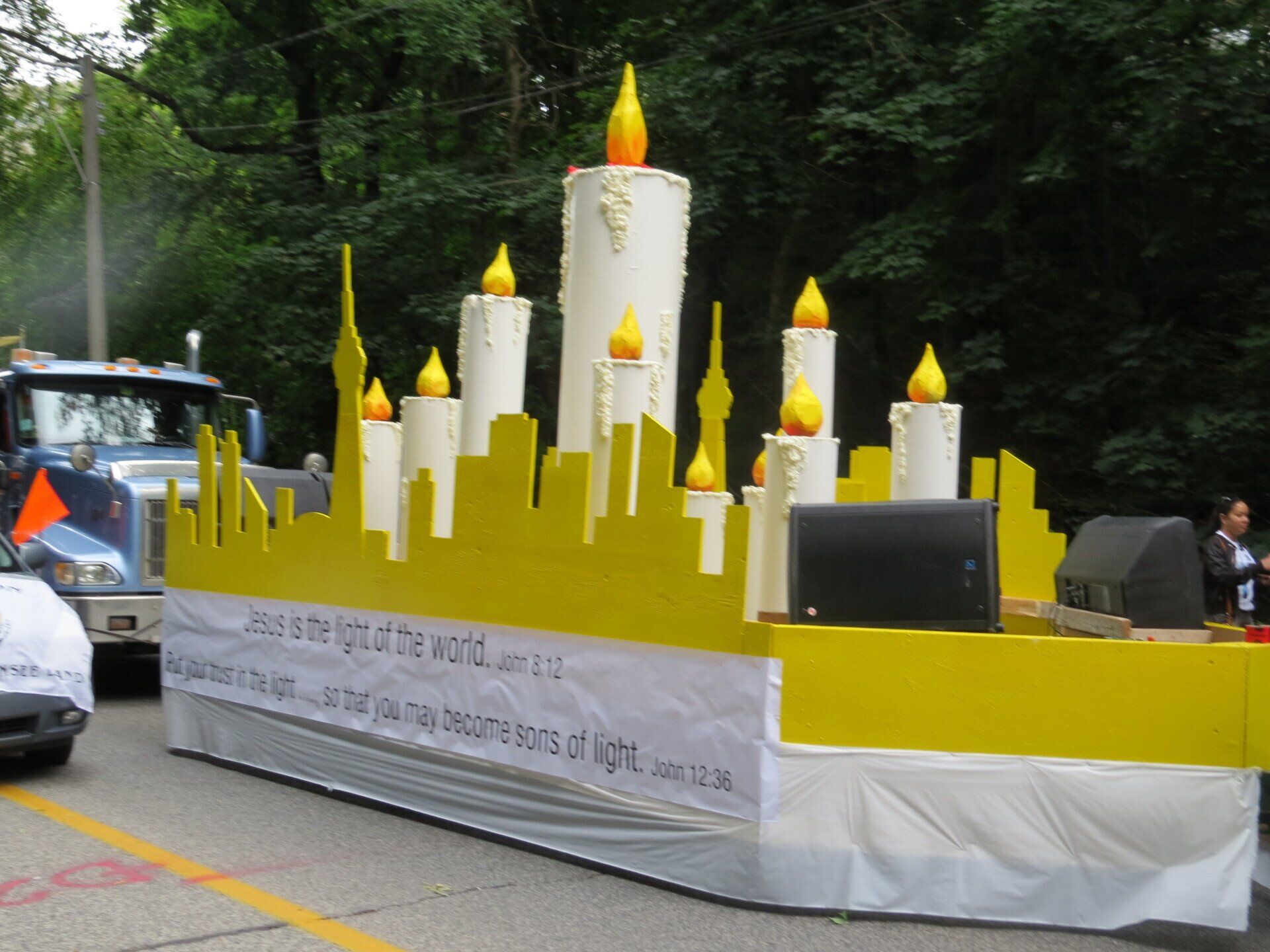 A float with candles and a sign that says jesus is the light of the world