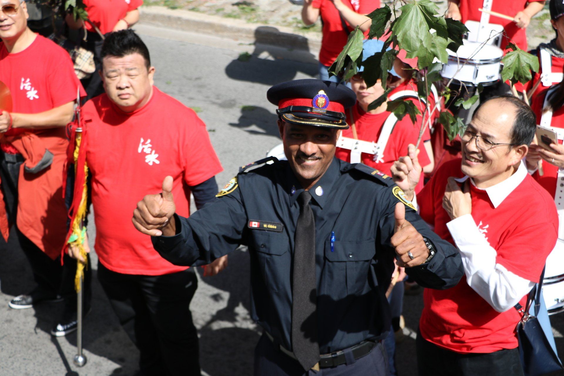 A man in a police uniform is giving a thumbs up