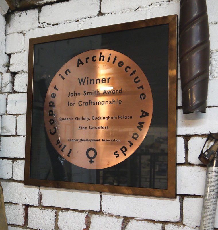 A framed copper in architecture award for john smith