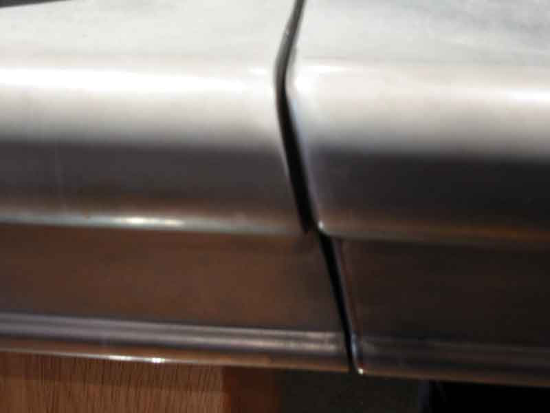A close up of a stainless steel door on a car