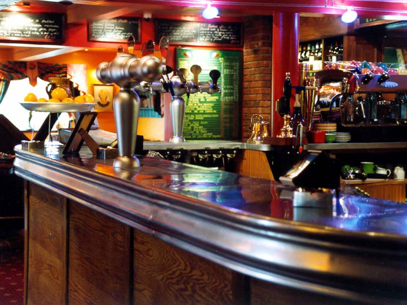 A bar with a sign on the wall that says ' a ' on it