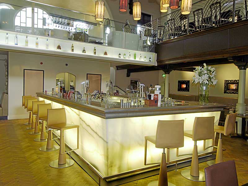 A restaurant with a long bar and stools