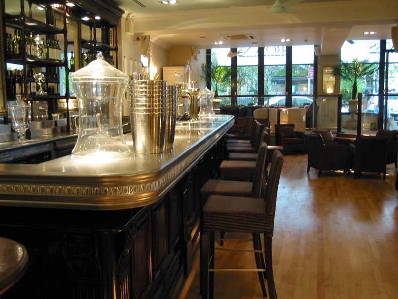 A bar in a restaurant with a lot of stools