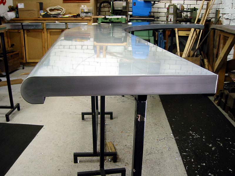 A long stainless steel table in a workshop