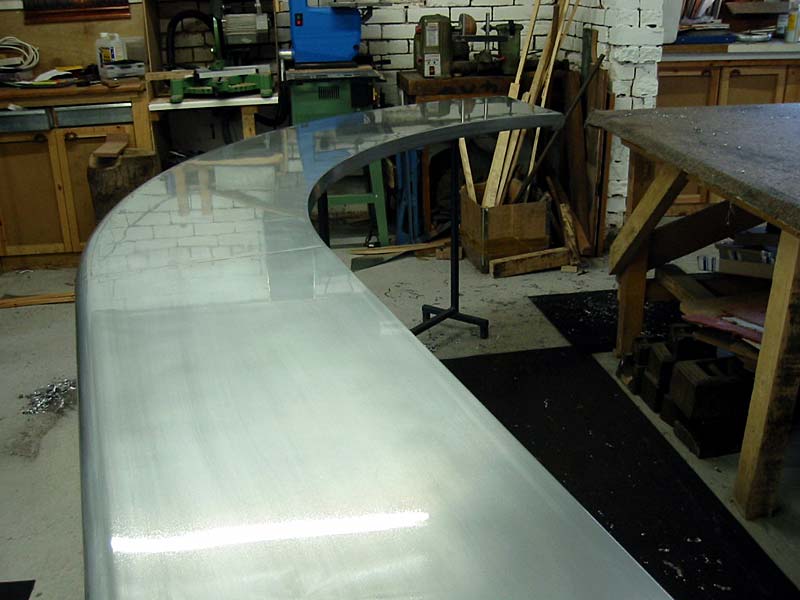 A curved stainless steel counter in a workshop
