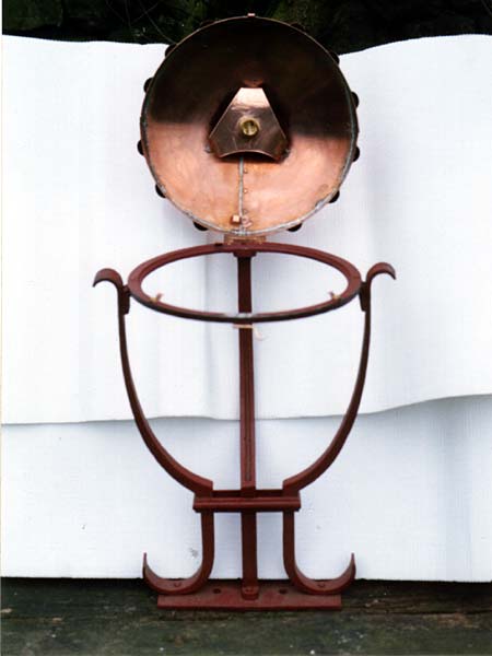 A copper object with the letter t on it