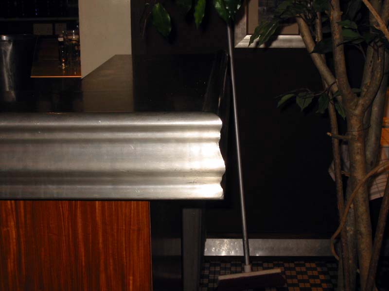 A broom is sitting on a counter next to a plant