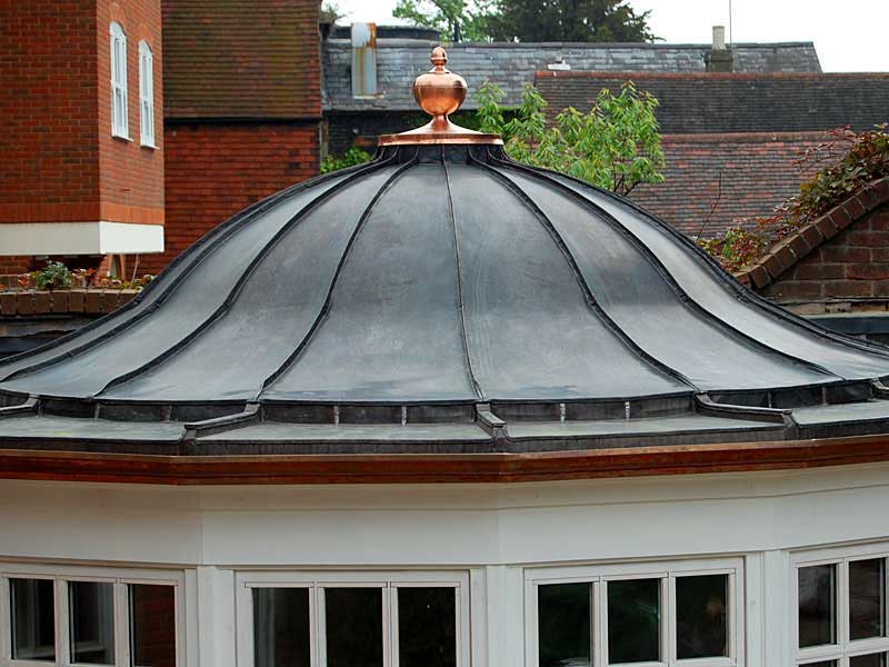A dome with a copper top is on top of a building