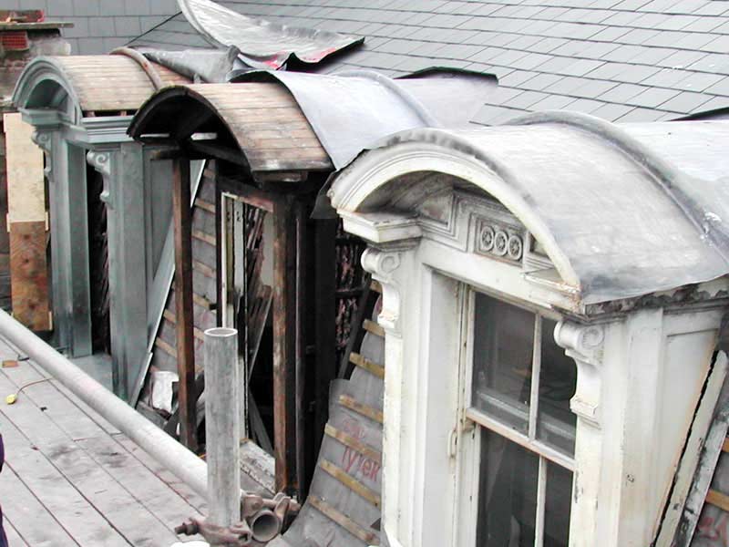 A building with arched windows and a roof that has a slate roof