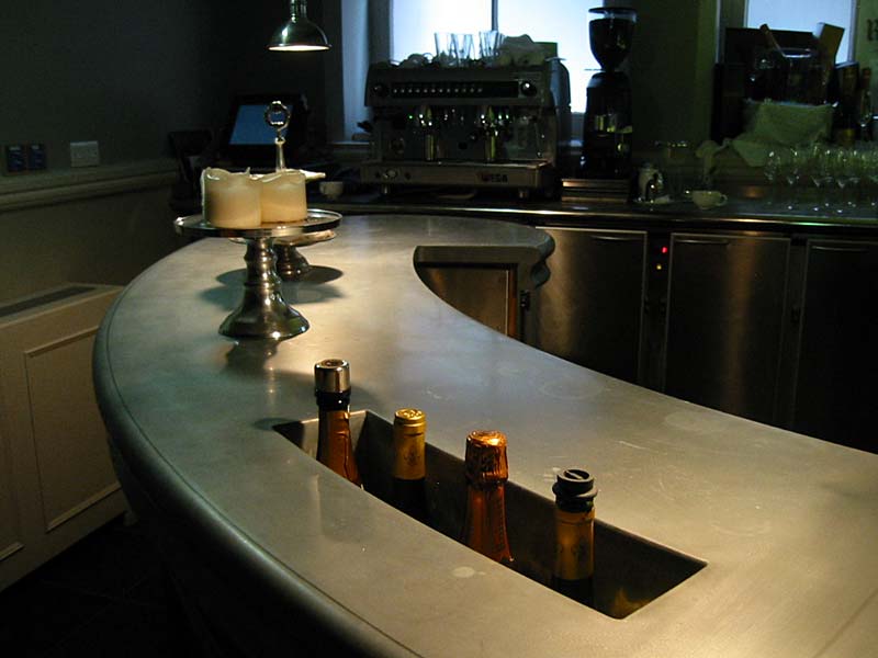 A stainless steel bar with bottles in it