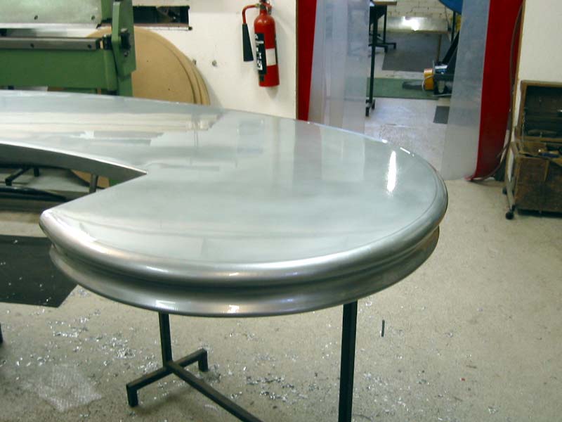 A metal table with a fire extinguisher in the background