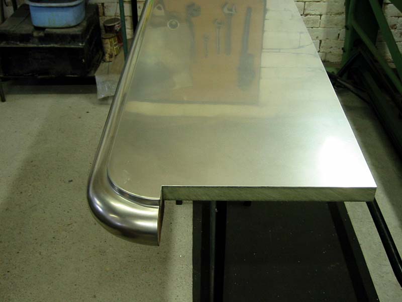 A stainless steel counter top with a curved edge