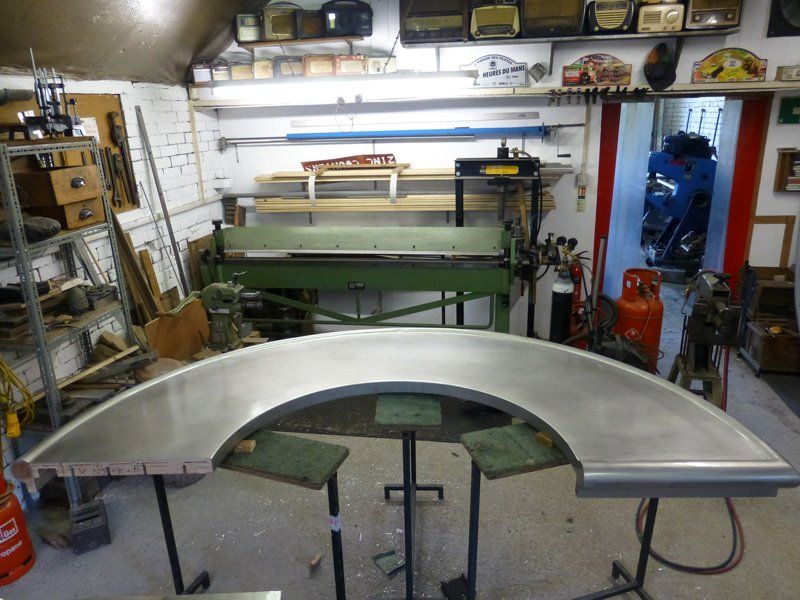 A stainless steel table is sitting in a garage