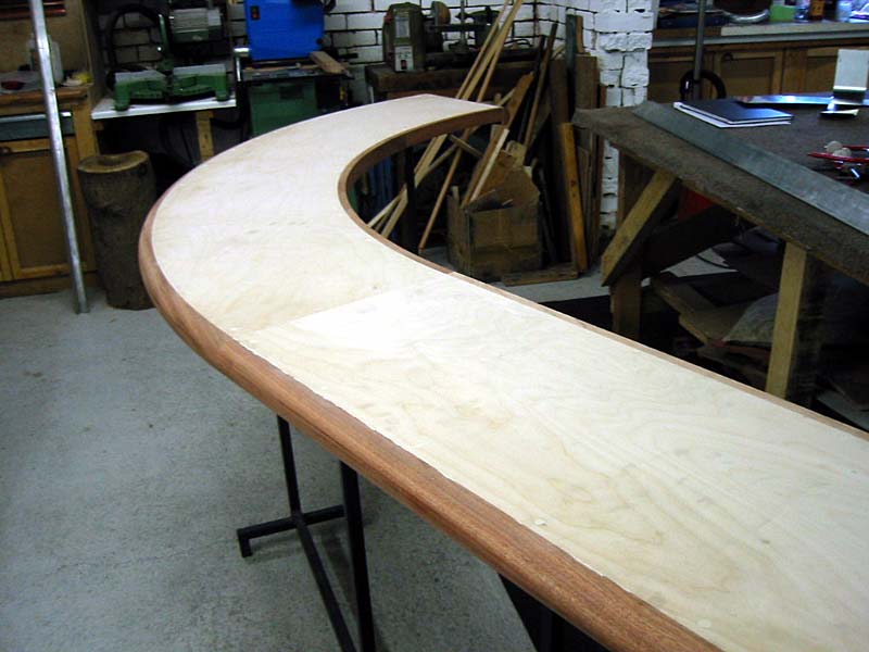 A curved piece of wood is sitting on a table