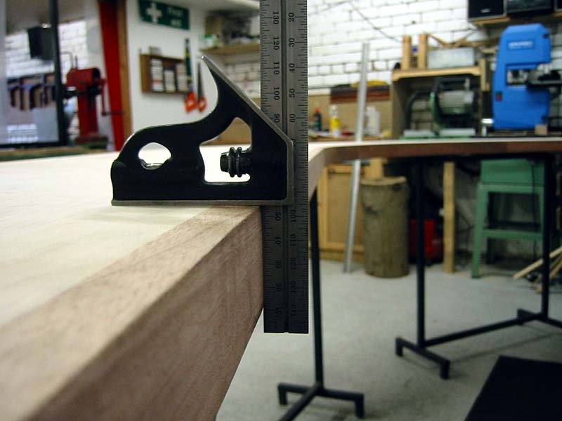 A ruler is being used to measure a piece of wood