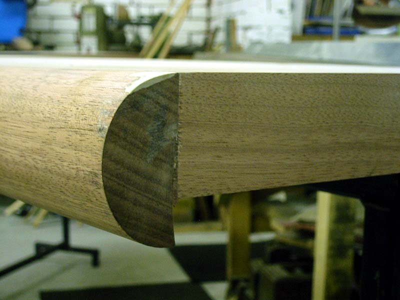 A close up of a wooden table top in a workshop.