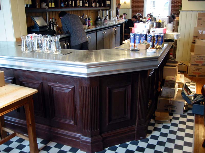 A bar in a restaurant with a checkered floor