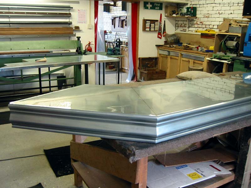 A large piece of metal is sitting on top of a wooden table
