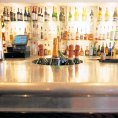 A bar with bottles of wine on the counter