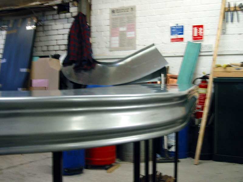 A metal table in a room with a fire extinguisher on the wall