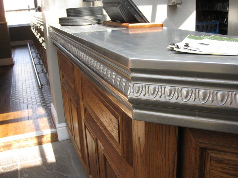 A kitchen counter with a newspaper on top of it