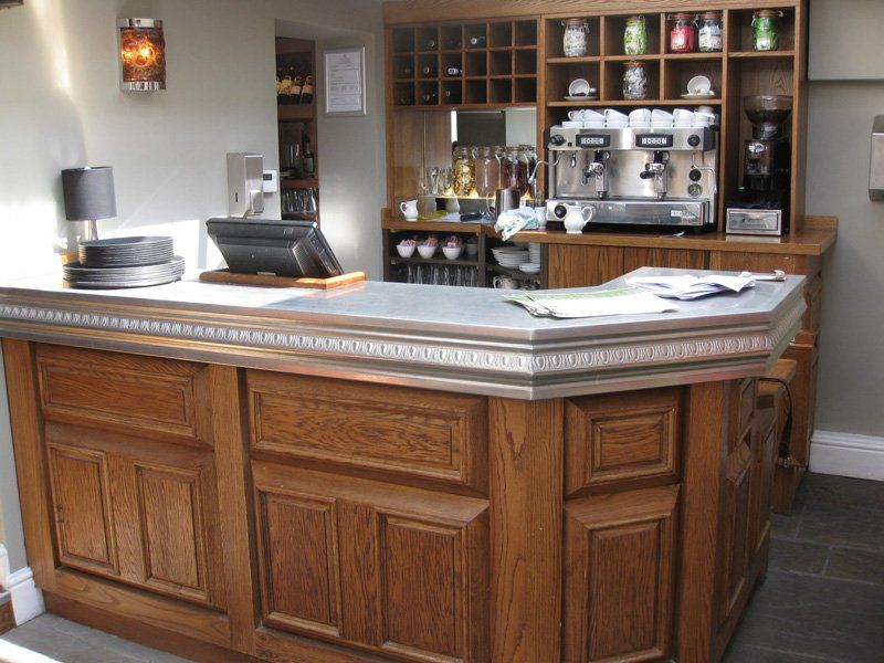 A wooden counter with a computer on top of it