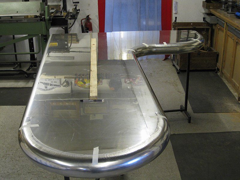 A stainless steel table in a room with a sign that says ' a ' on it
