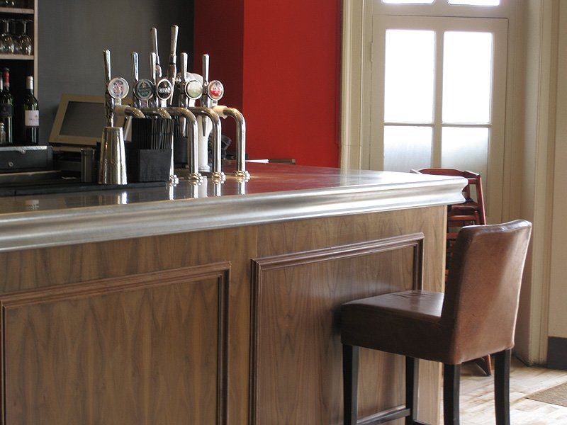 A bar with a lot of beer taps on it