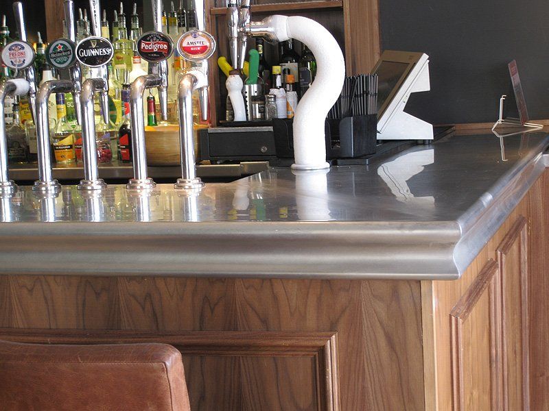 A bar with many taps including one that says guinness