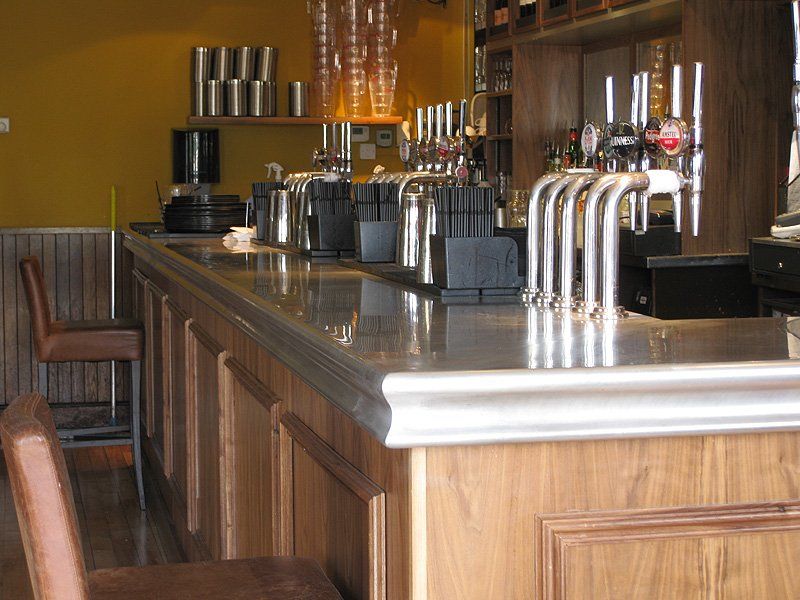 A bar with a lot of beer taps on it