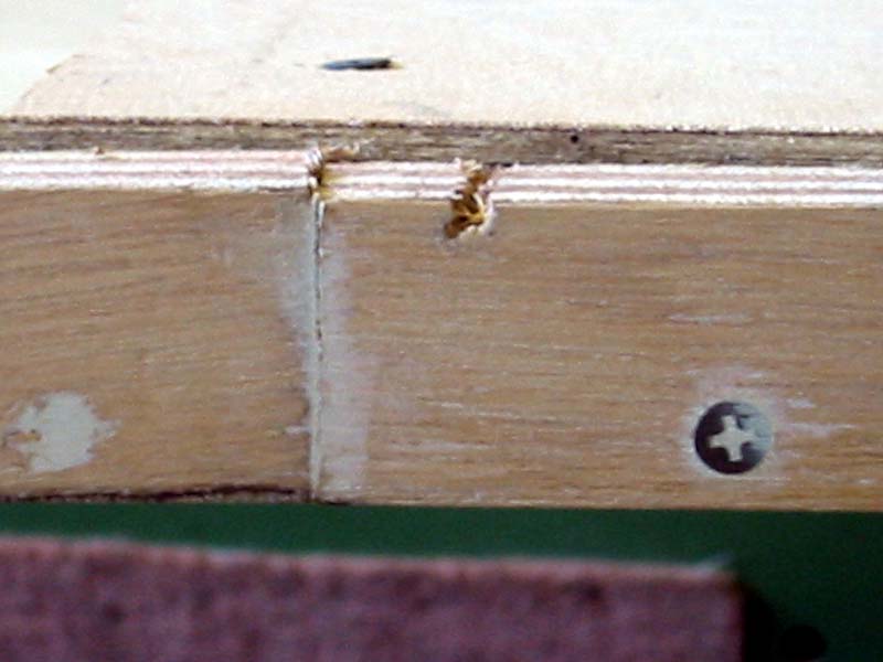 A close up of a piece of wood with a screw on it