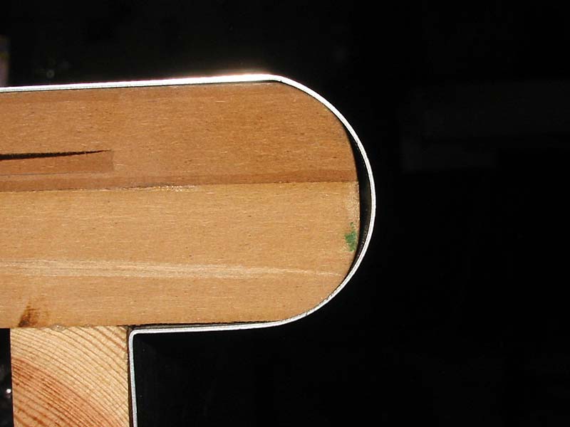 A close up of a piece of wood with a metal edge