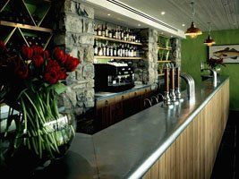 A bar with a vase of flowers on the counter