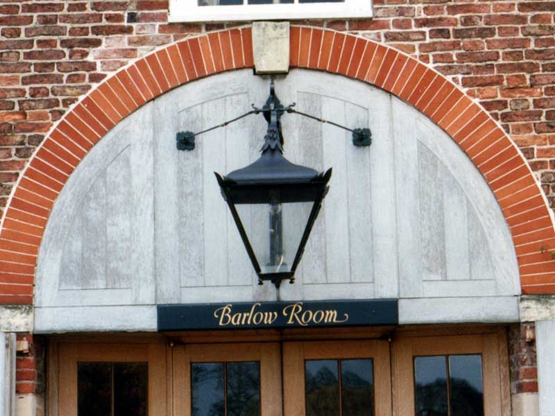 A brick building with a sign that says barlow room