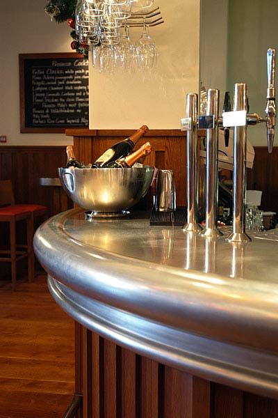 A bar with a bowl of champagne and glasses on it.