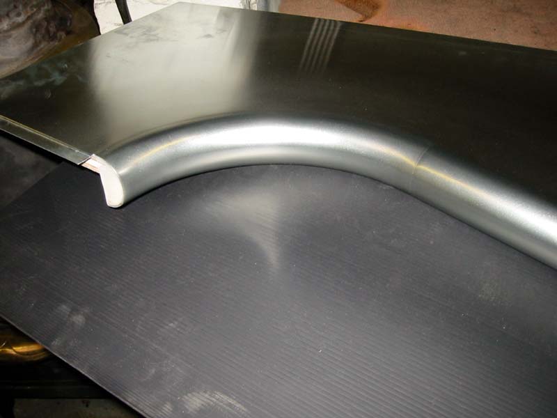 A piece of metal is sitting on top of a black table.